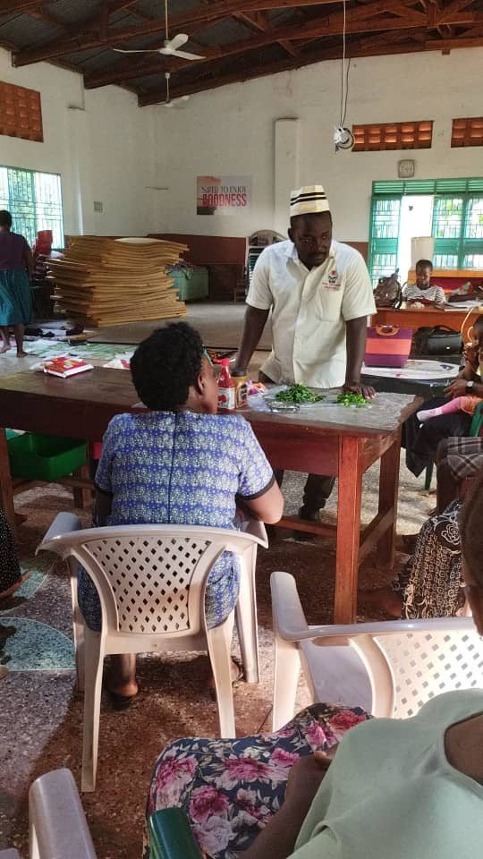 A woman being trained in a livelihood skill by a Turikumwe instructor
